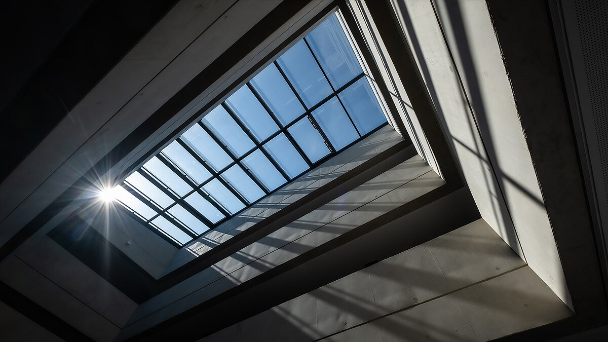 View of the glass roof at the Bertha-von-Suttner Realschule in Cologne, featuring sunlight and shadow effects.