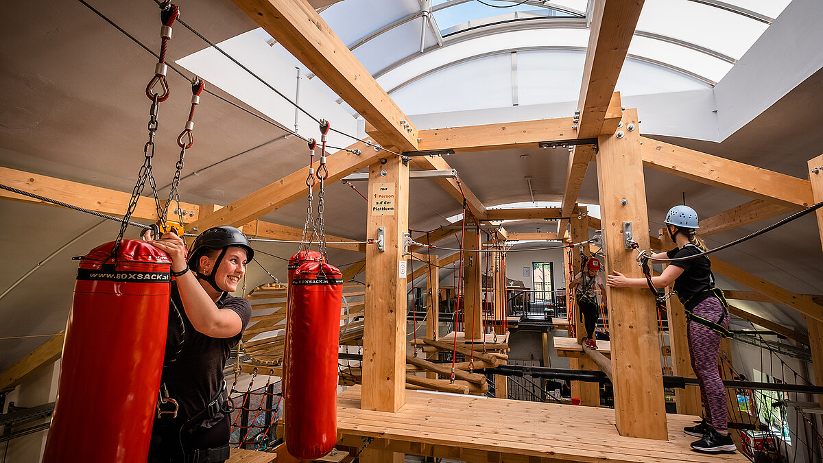 Climbing hall in Eisenach with wooden structures and climbing elements, illuminated by LAMILUX skylight bands B.