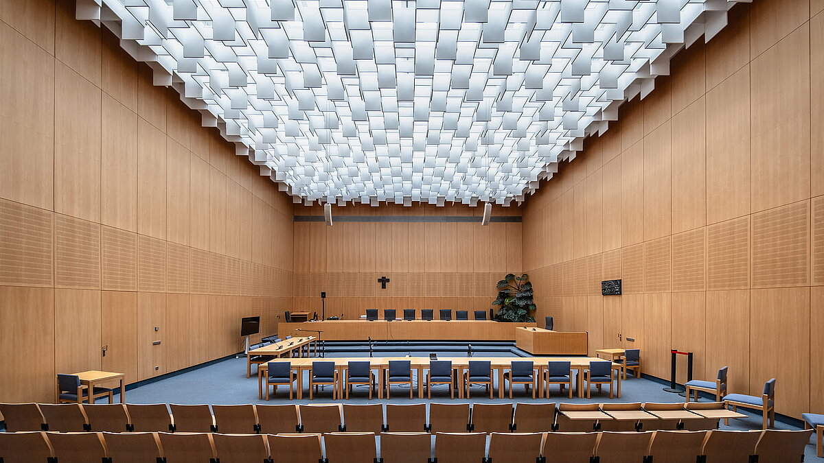 Courtroom in the Weiden district court featuring distinctive skylights and geometric ceiling structure.