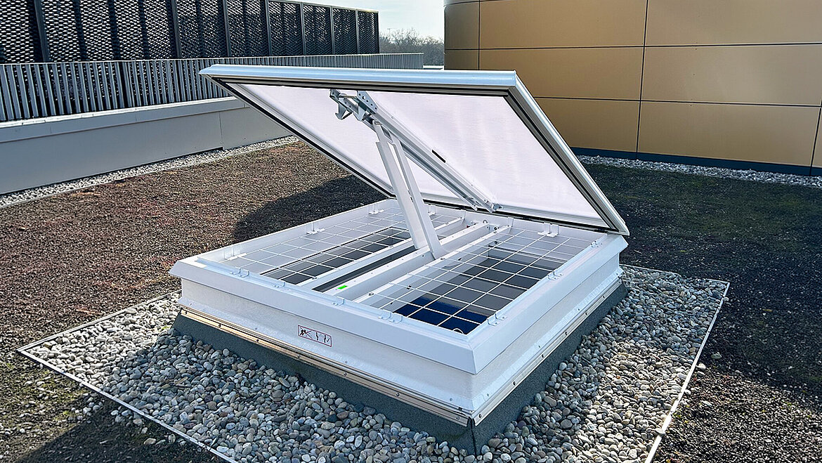 Open LAMILUX Skylight on a gravel roof for natural ventilation and daylight illumination