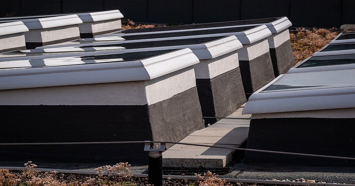 Flat roof with modular flat roof windows arranged in rows.