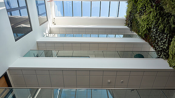 View from below of LAMILUX Glass Roof PR60 with white beams and glass panels