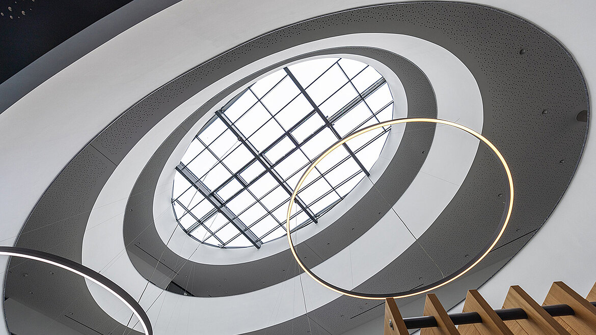 Modern atrium with oval glass roof PR60 providing natural daylight illumination