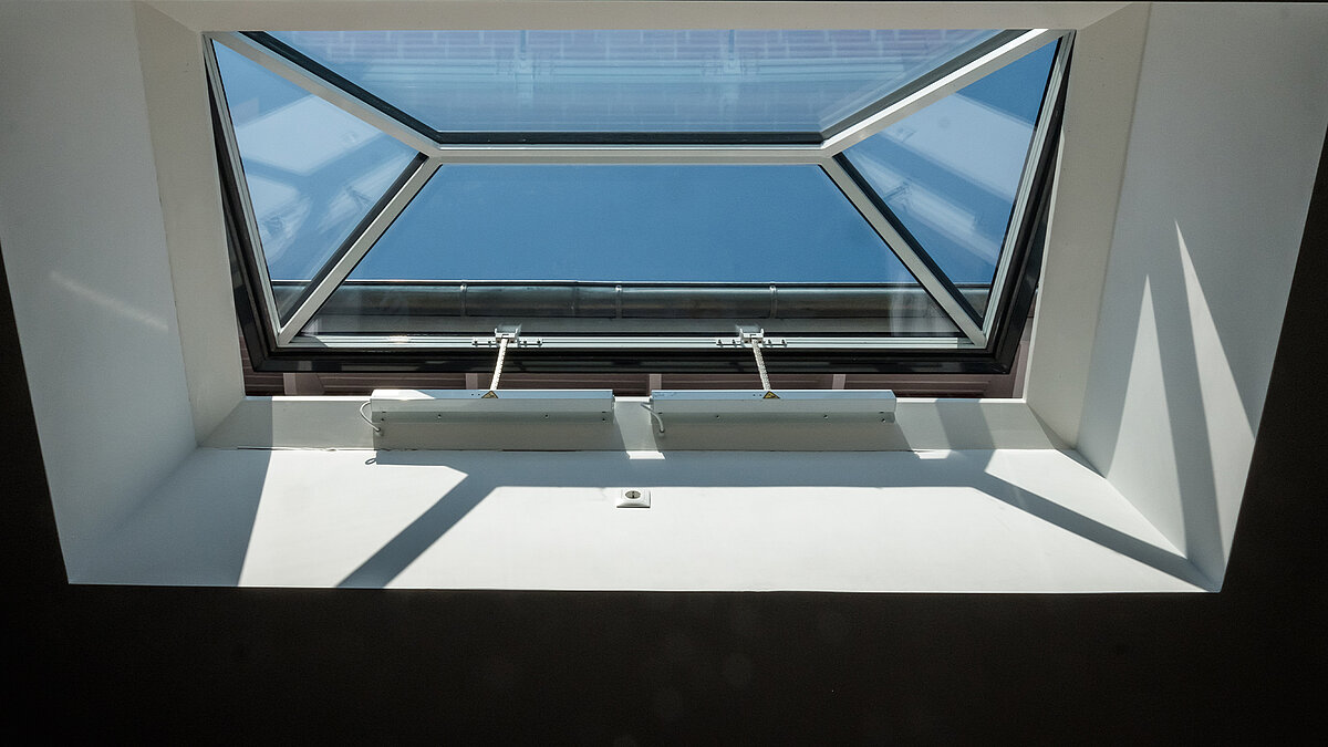 Interior view of a flat roof window by LAMILUX in a residential building in Hamburg, providing abundant natural light.
