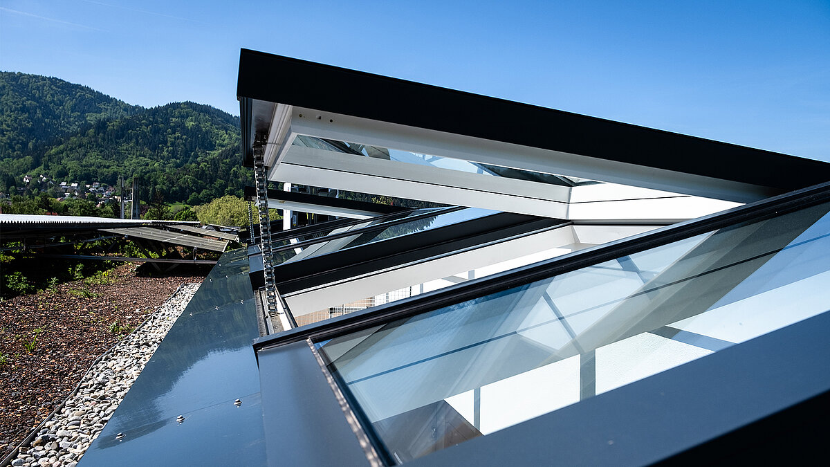 Residential building in Freiburg with modular glass roofs from LAMILUX, view of the open roof construction.