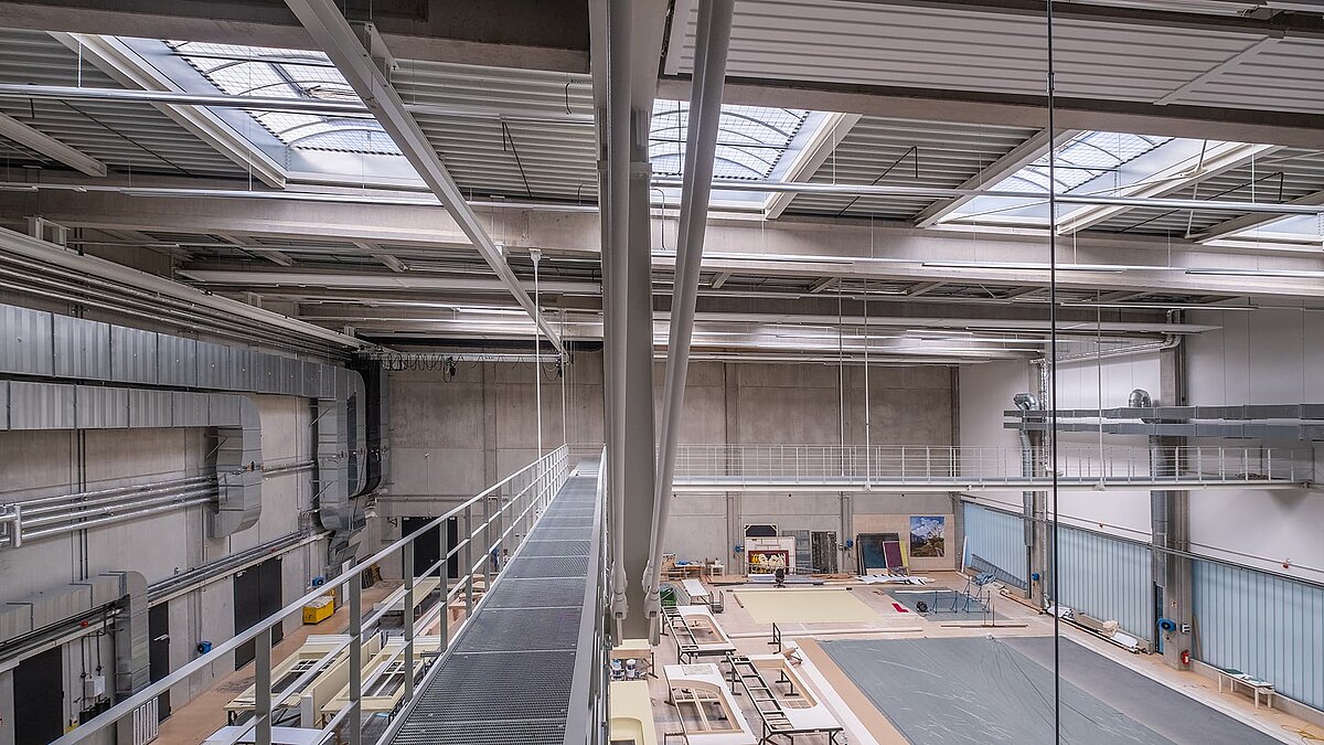 Hamburg opera storage facility with LAMILUX B continuous rooflight and large stage set workshop.