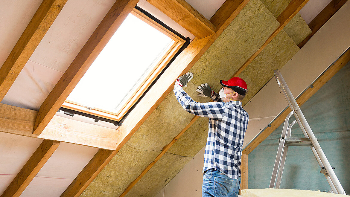 Roof renovation with insulation and roof window in a converted attic