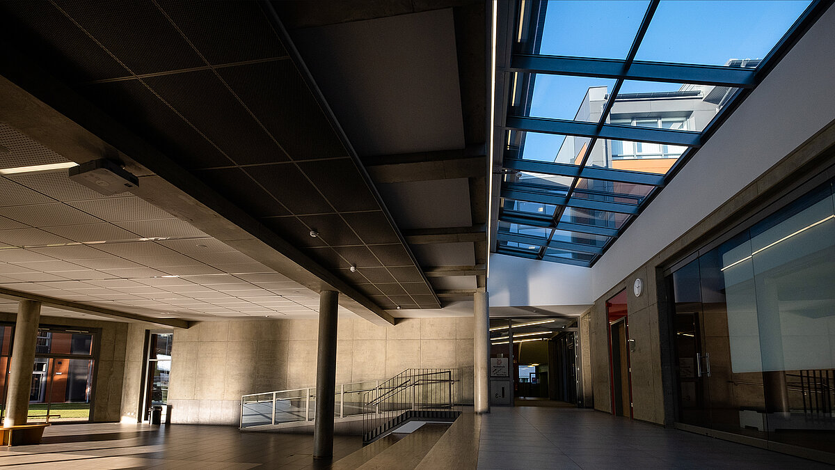 Interior of the Rehau school center with a modern LAMILUX PR60 glass roof allowing natural daylight into the space.