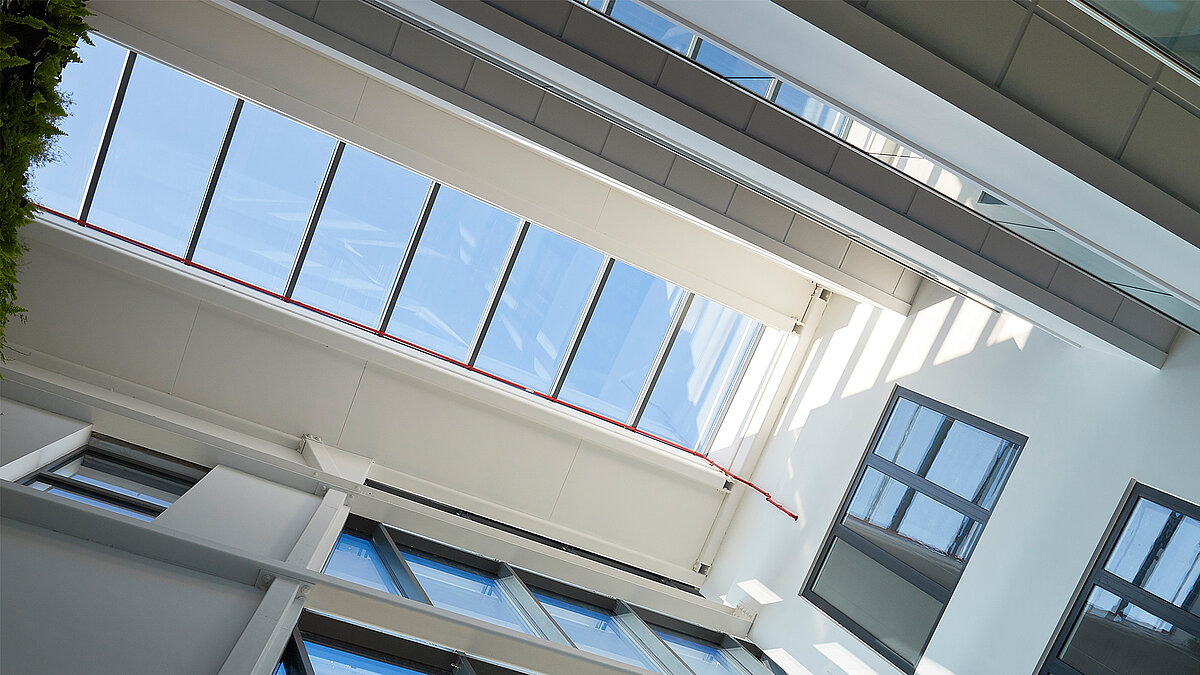 Interior view with LAMILUX Glass Roof PR60 and white steel structure in the atrium