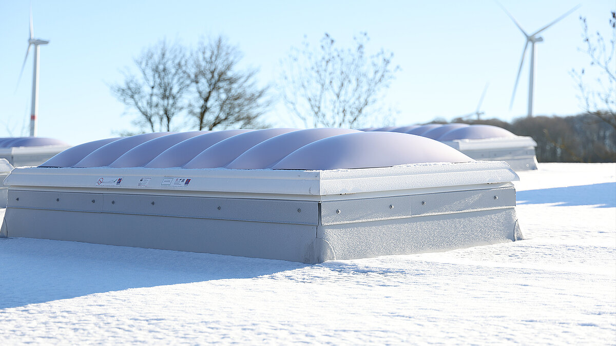 Snow-covered skylights on the roof of the "Ab in die Box" building at Diemelsee.
