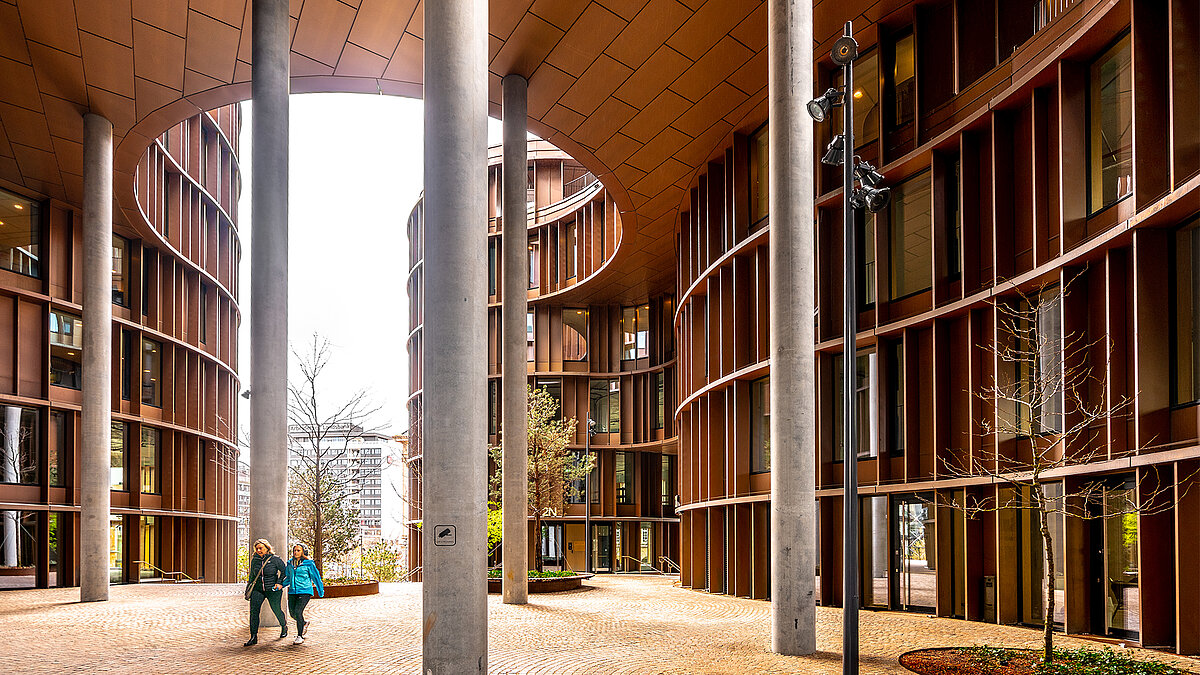 Modern courtyard with a curved façade and tall columns
