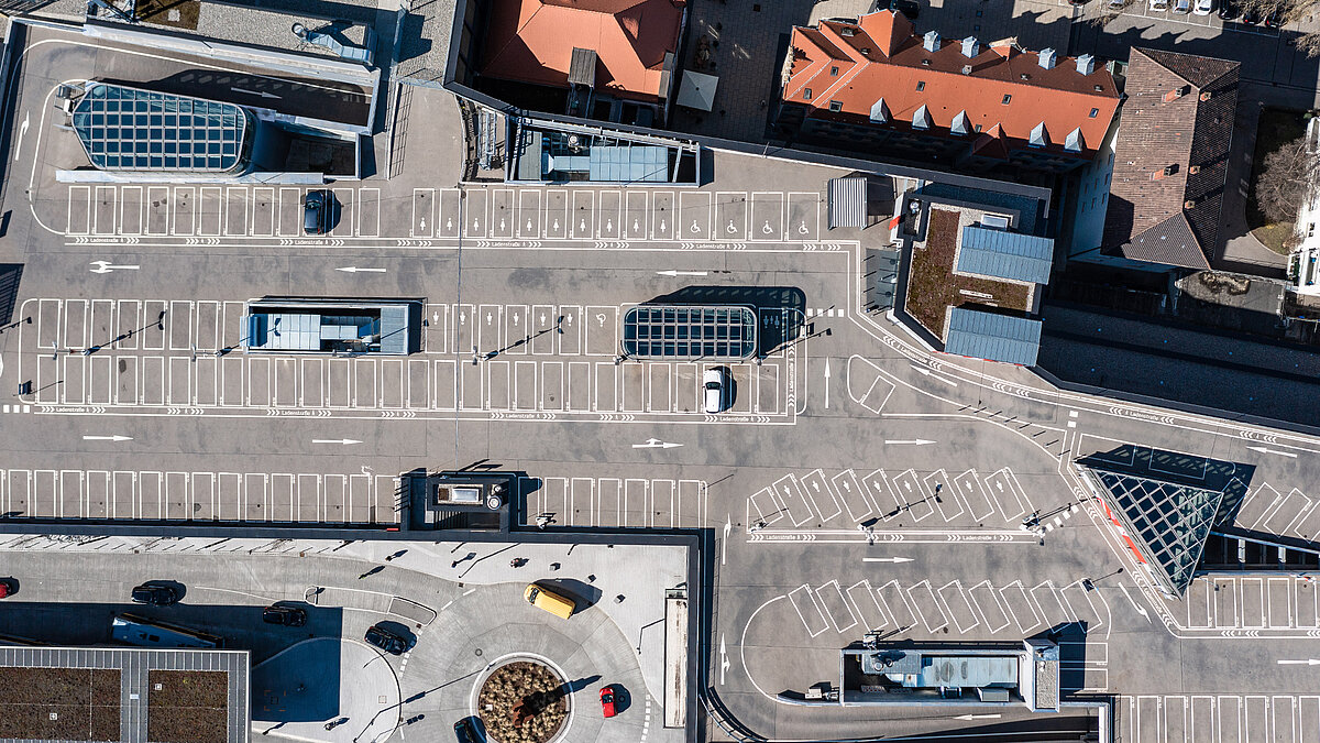 Cano shopping center Singen with parking deck, glass roofs and marked parking spaces in aerial view