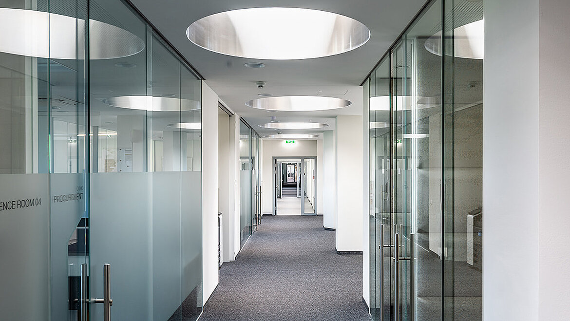 Modern office corridor with round flat roof windows for natural daylight