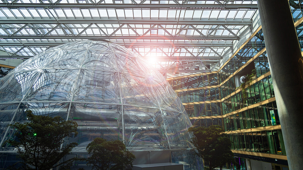 EUREF Campus Düsseldorf with modern glass architecture and sunlight in the courtyard