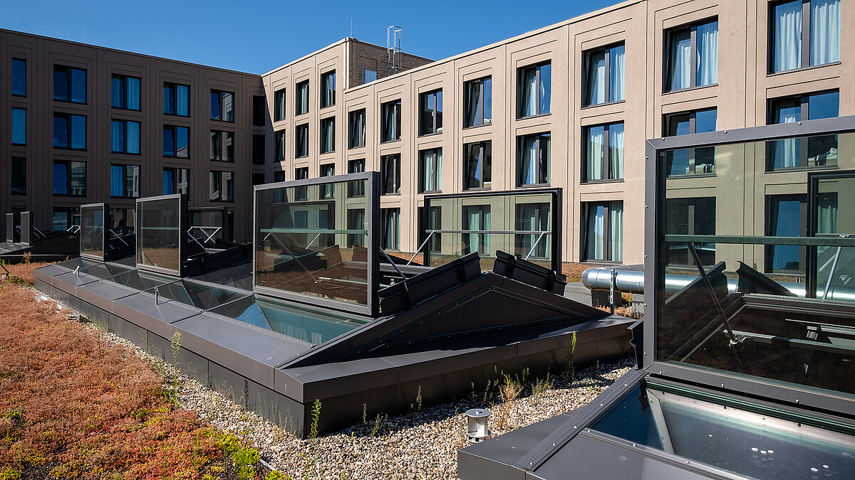Open glass roofs from LAMILUX on the green roof of the Schultheiss Quartier in Berlin-Moabit.