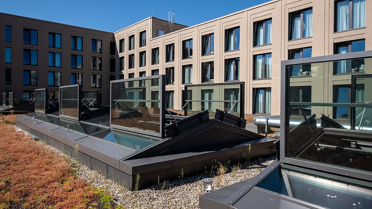 Open glass roofs from LAMILUX on the green roof of the Schultheiss Quartier in Berlin-Moabit.