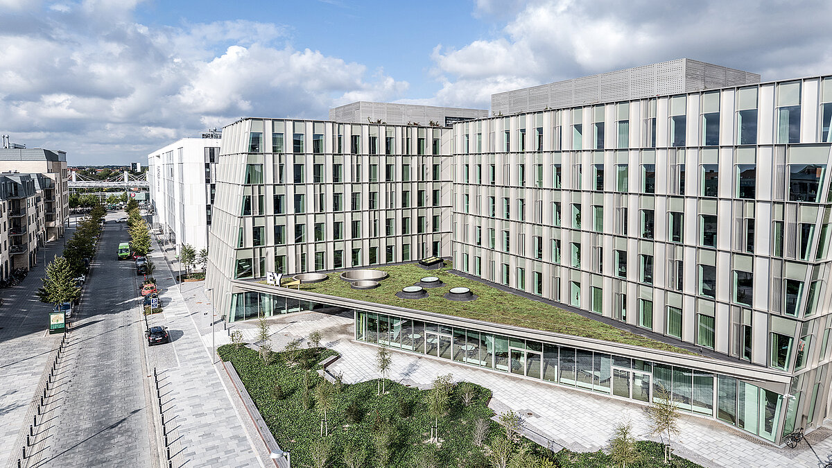 Ernst & Young office building with modern facade architecture, green roof and courtyard