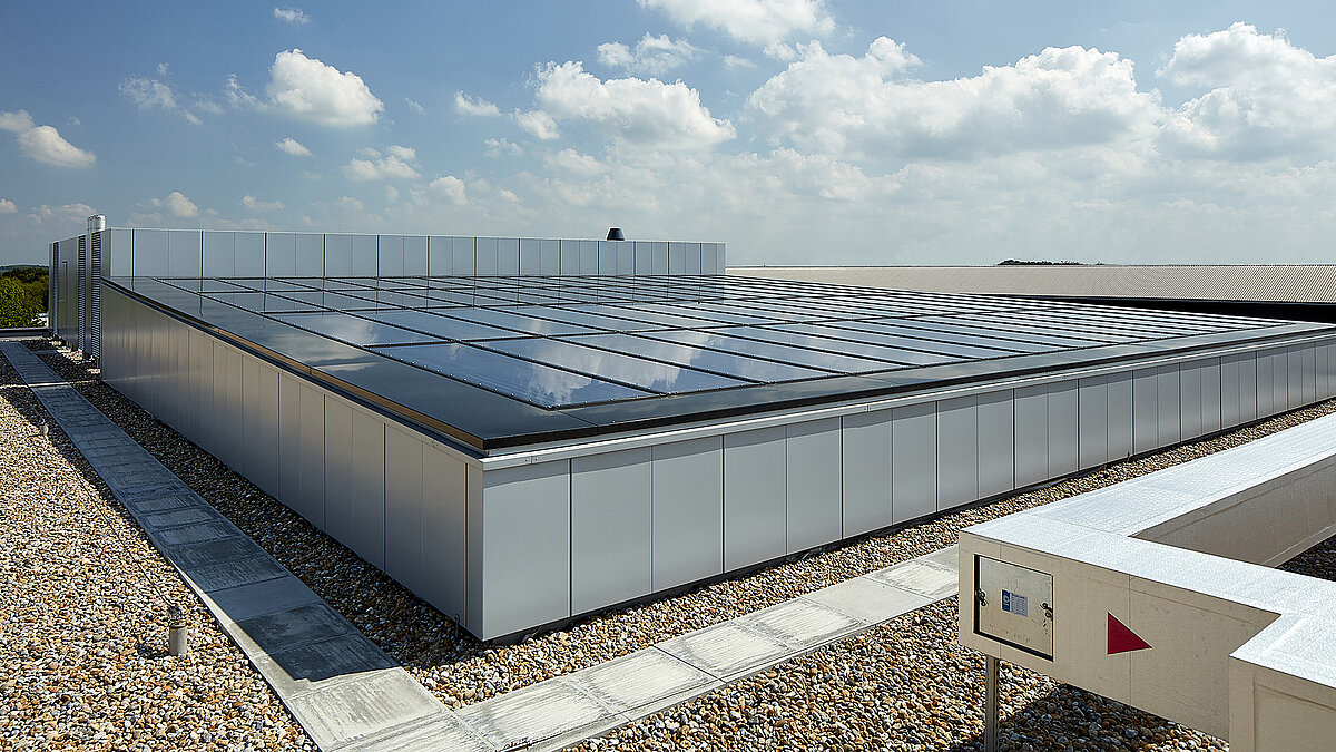 Glass roof of a modern commercial building in Milton Park, England, reflecting the sky and providing natural illumination.