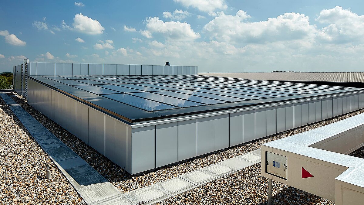 Glass roof of a modern commercial building in Milton Park, England, reflecting the sky and providing natural illumination.