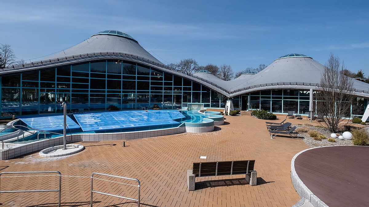 Outdoor area of the Solemar thermal spa in Bad Dürrheim featuring a curved glass dome and swimming pool.