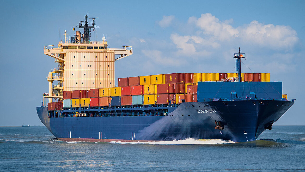 Large container ship with colorful freight containers at sea