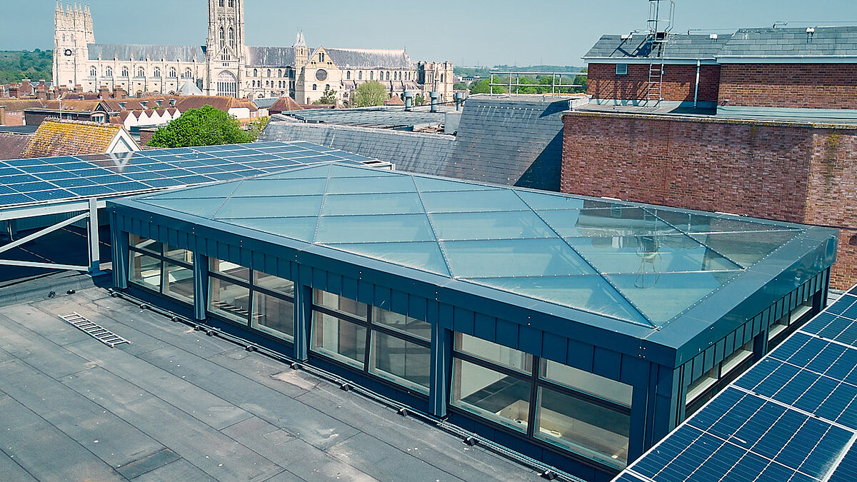 Rooftop view of Canterbury City Council with LAMILUX PR60 glass roof and surrounding solar panels.