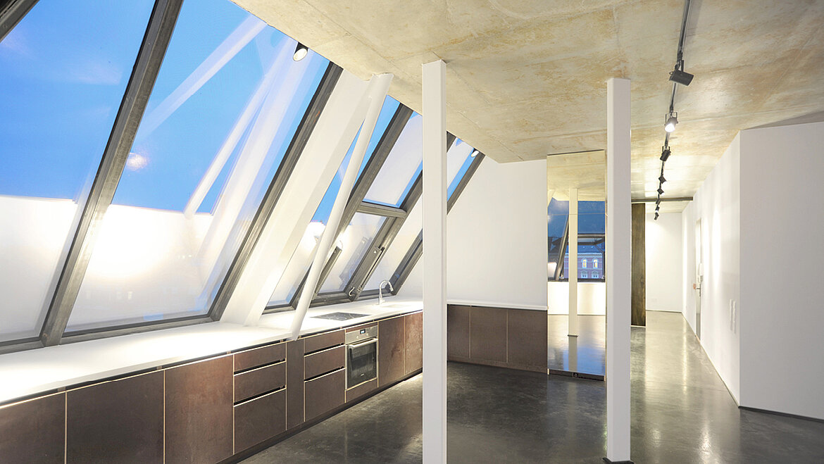 The interior of a converted attic with kitchenette.