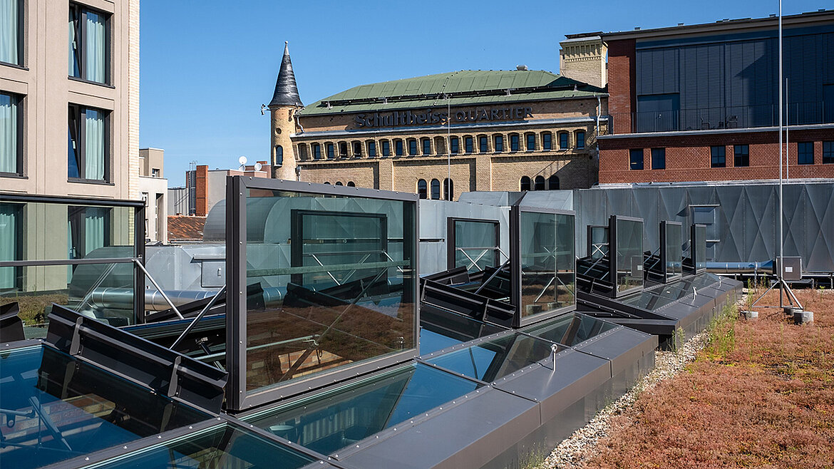Open skylights on a green flat roof overlooking Berlin's historic Schultheiss Quarter
