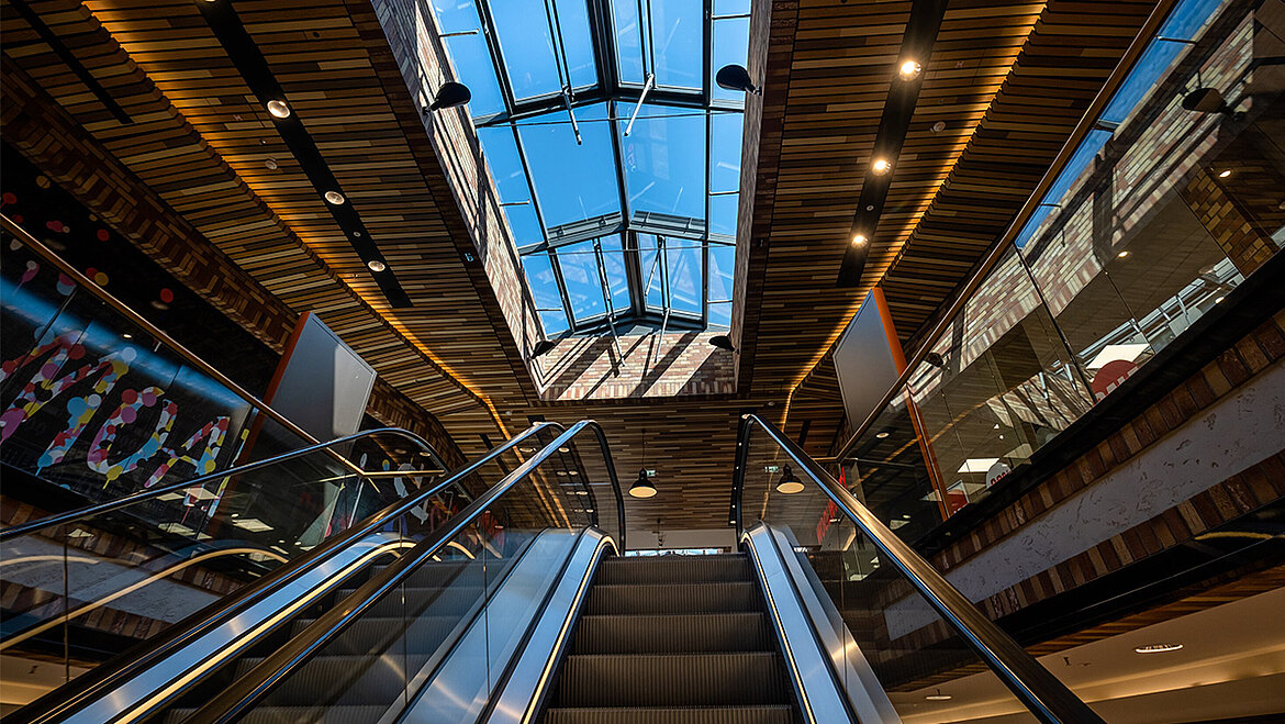 Shopping mall with glass roof above escalators