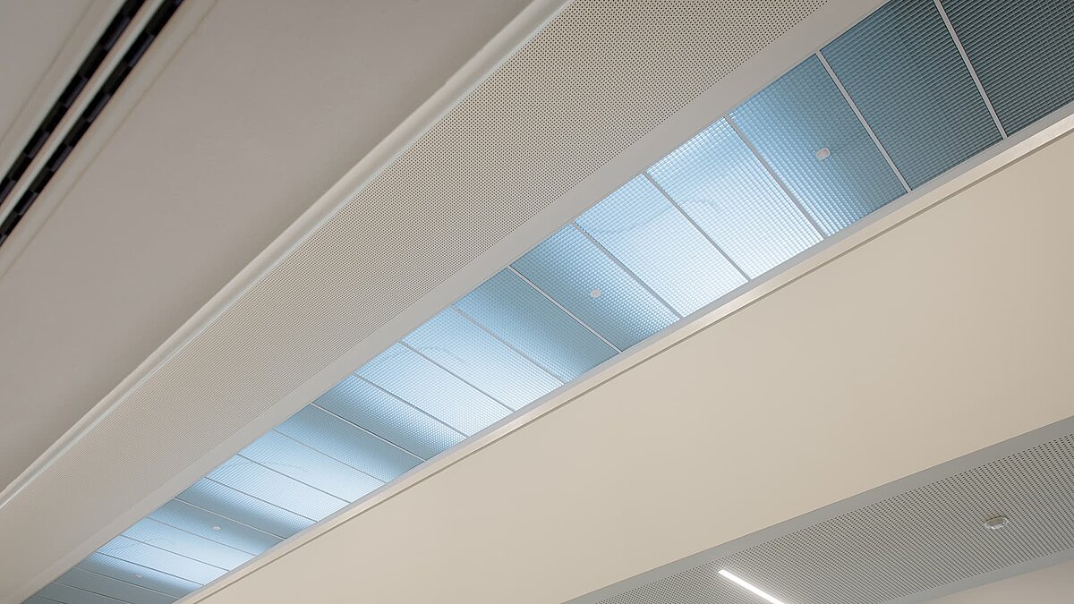 Interior view of a flat roof window at the Markgraf-Georg-Friedrich-Gymnasium in Kulmbach, featuring blue-tinted glass for natural light.
