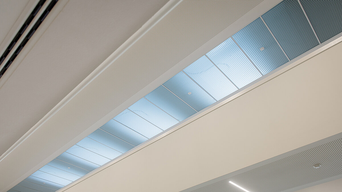 Interior view of a flat roof window at the Markgraf-Georg-Friedrich-Gymnasium in Kulmbach, featuring blue-tinted glass for natural light.