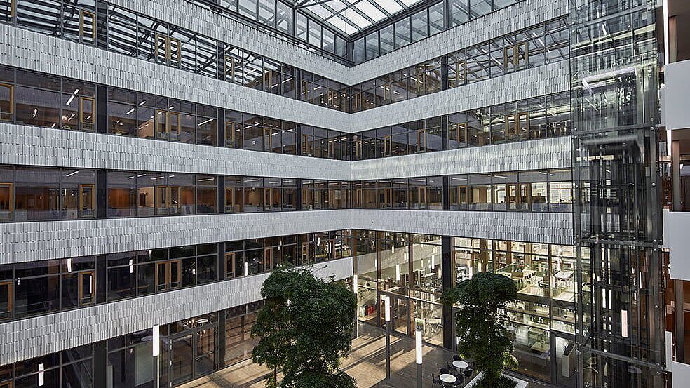 Daytime view of the modern Luxembourg Post building featuring the LAMILUX PR60 Passive House glass roof construction and light-filled atrium.