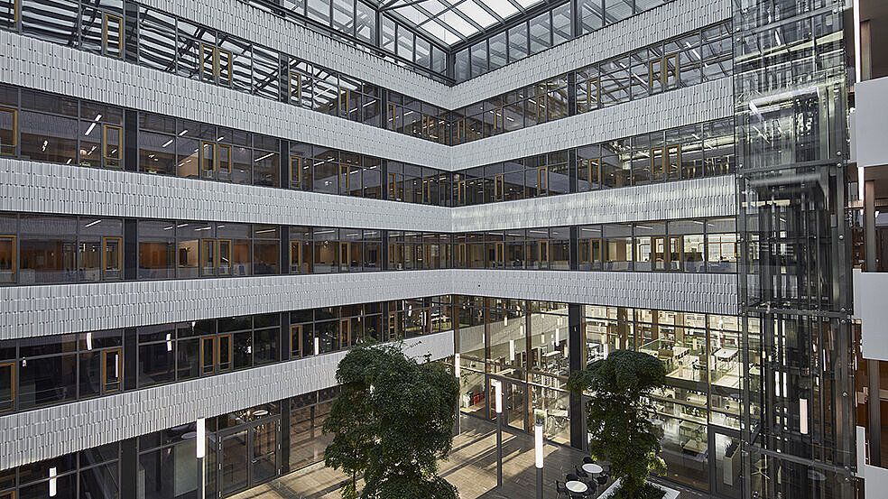 Daytime view of the modern Luxembourg Post building featuring the LAMILUX PR60 Passive House glass roof construction and light-filled atrium.