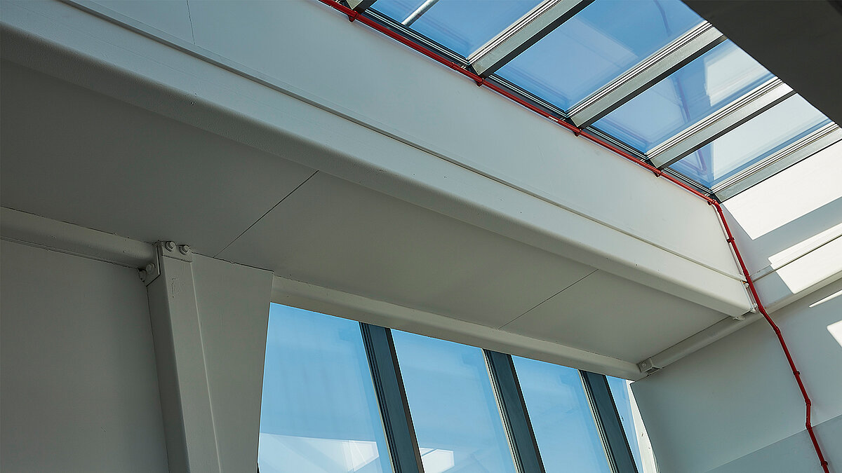 Interior view with LAMILUX Glass Roof PR60, white beams and large glazed panels