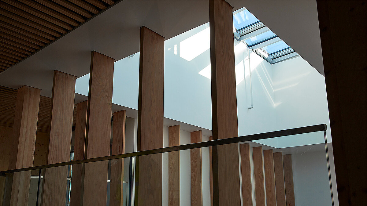 Harris Academy Sutton featuring a light-filled atrium with vertical timber columns and rectangular glass roof