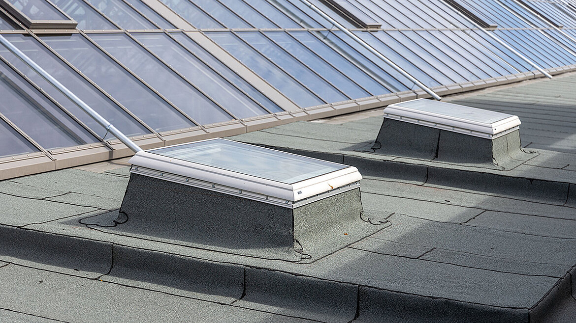 Glass Skylights on a gray bitumen roof