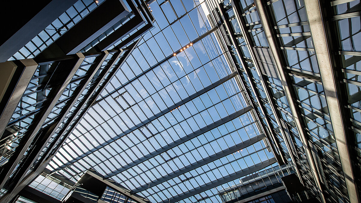 Modern glass roof at FGS Campus with large glass panels and clear sky reflections.