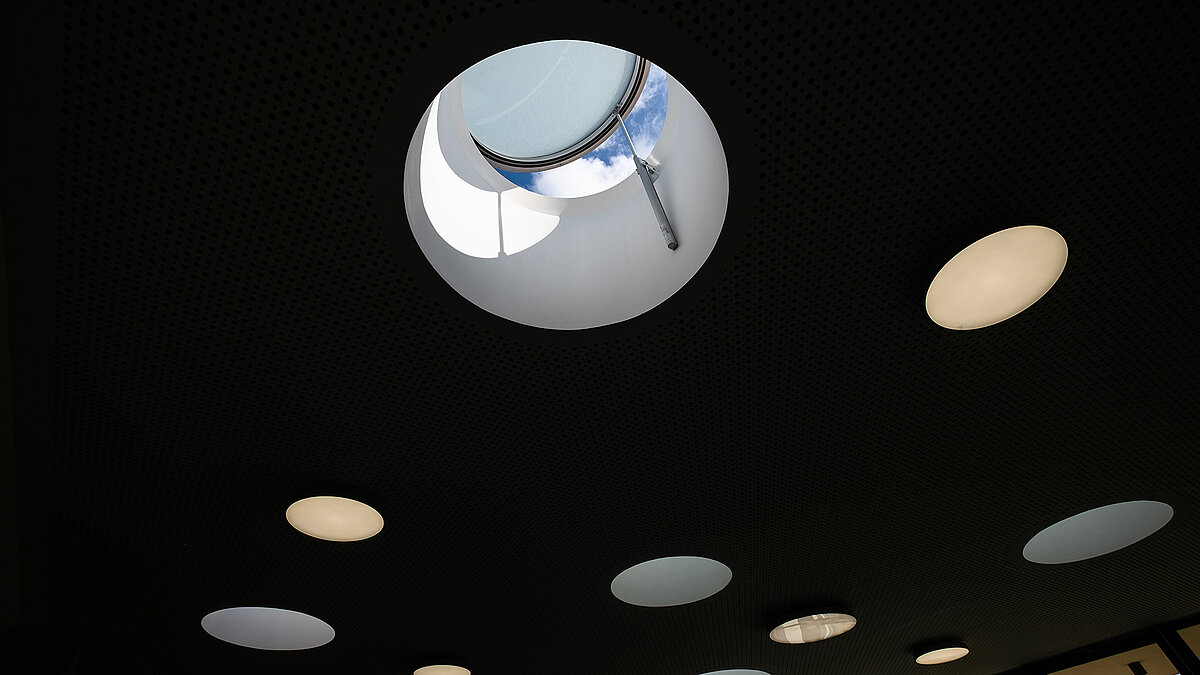 Ceiling of the "Sonnenfeld" daycare center in Wandlitz with round skylights, one open showing the sky.