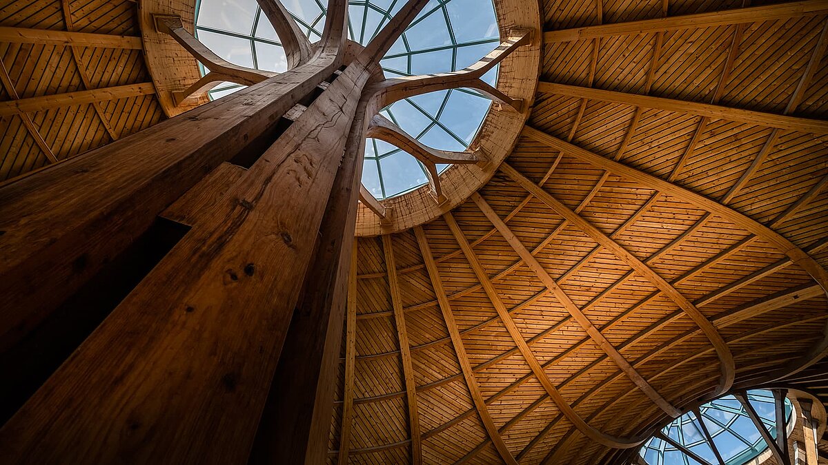 View of the impressive glass dome at the Solemar thermal spa in Bad Dürrheim, supported by an artistic wooden structure.