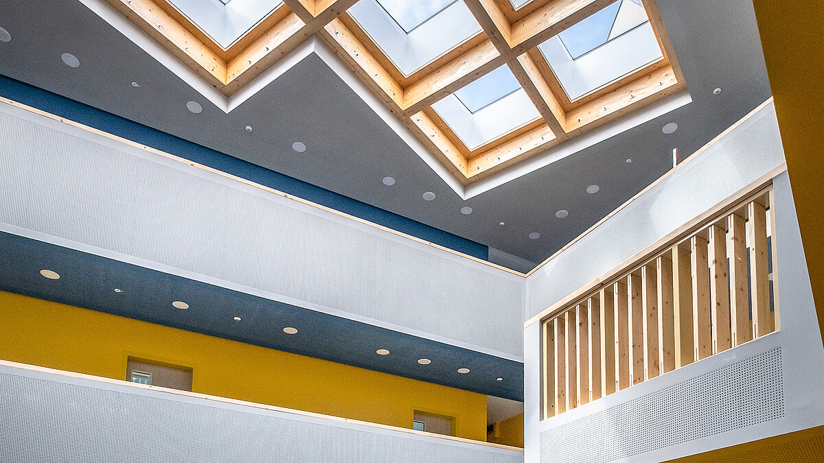 Bright atrium with wooden frames and LAMILUX Glass Skylights 
