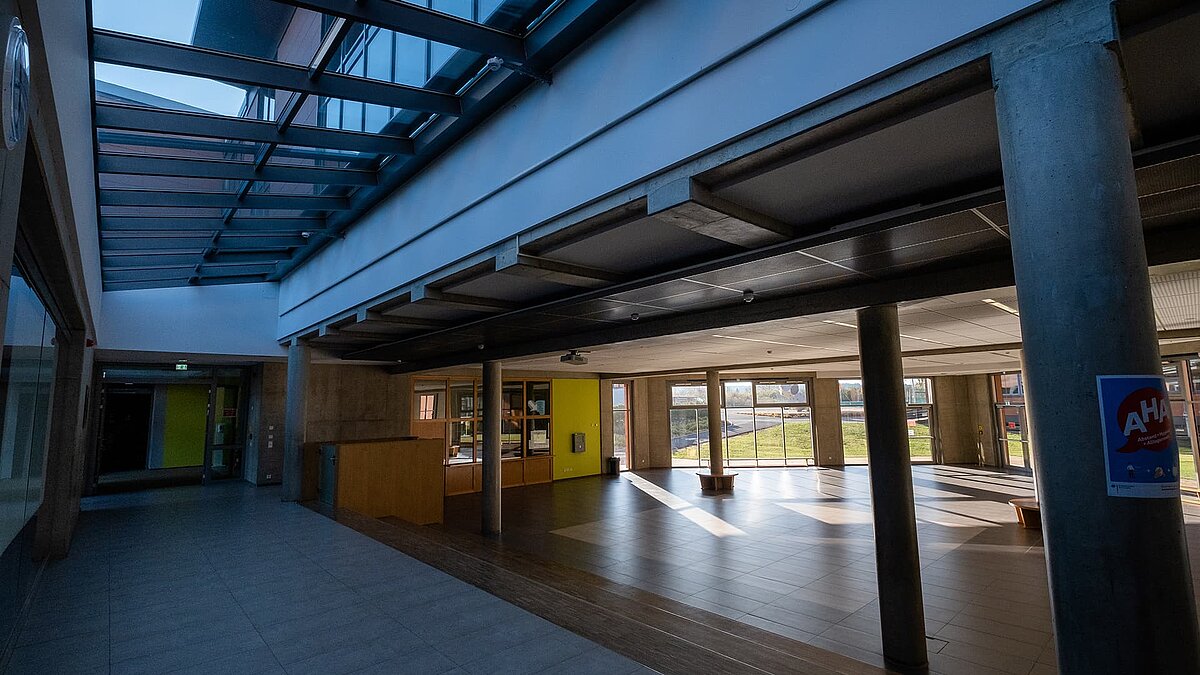 Interior of Rehau school center featuring the LAMILUX PR60 glass roof, providing natural light to the space.