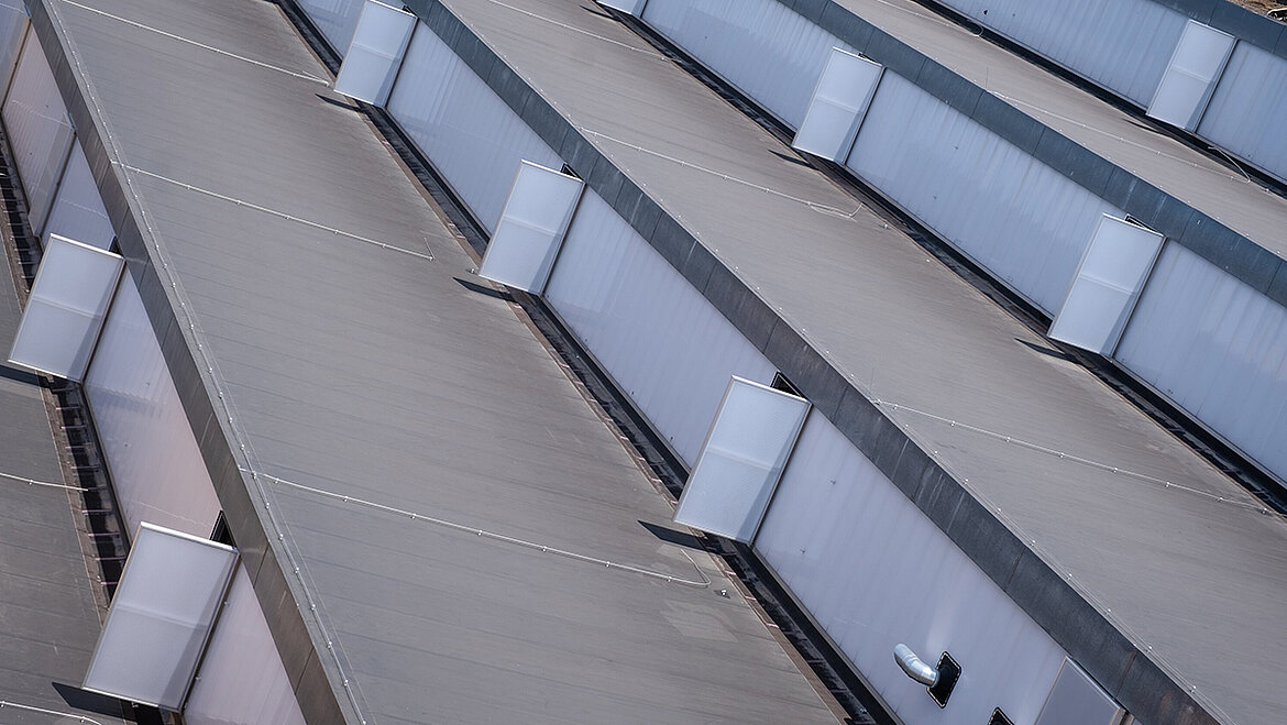 Aerial view of an industrial roof with skylights and ventilation