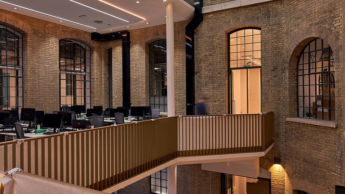 Interior with glass roof, brick walls, and modern lighting