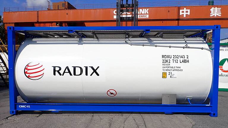 White ISO tank container labeled "RADIX" with GRP tank cladding