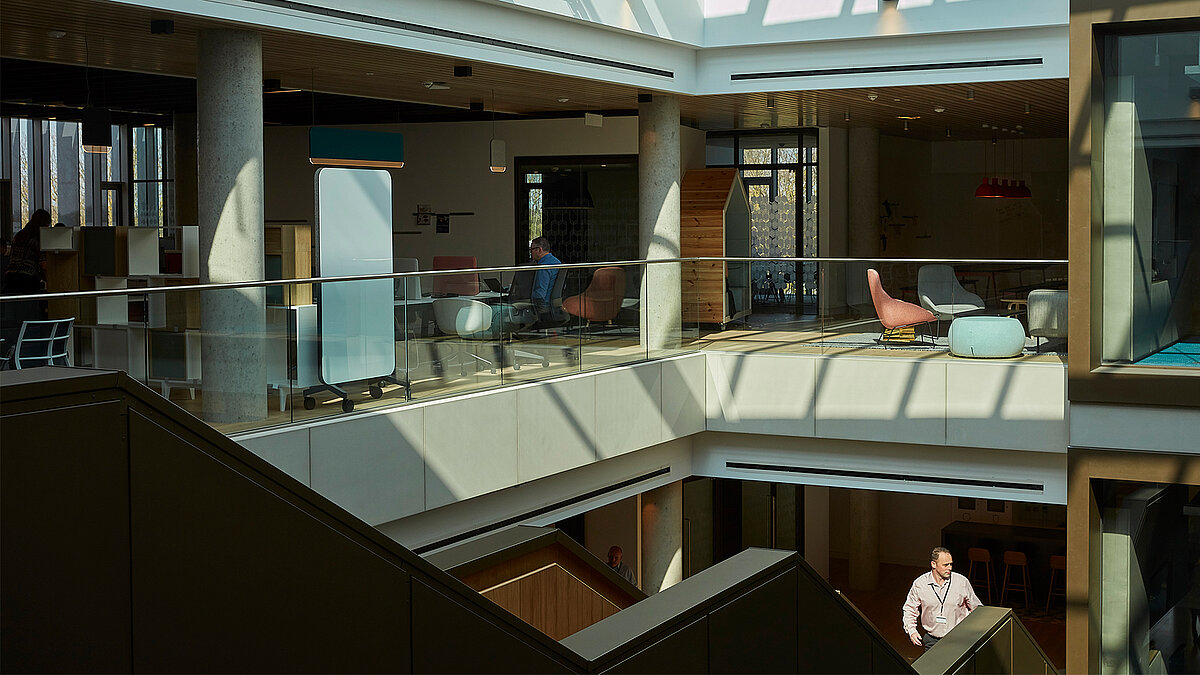 Modern office building with multiple levels, glass railings and open atrium