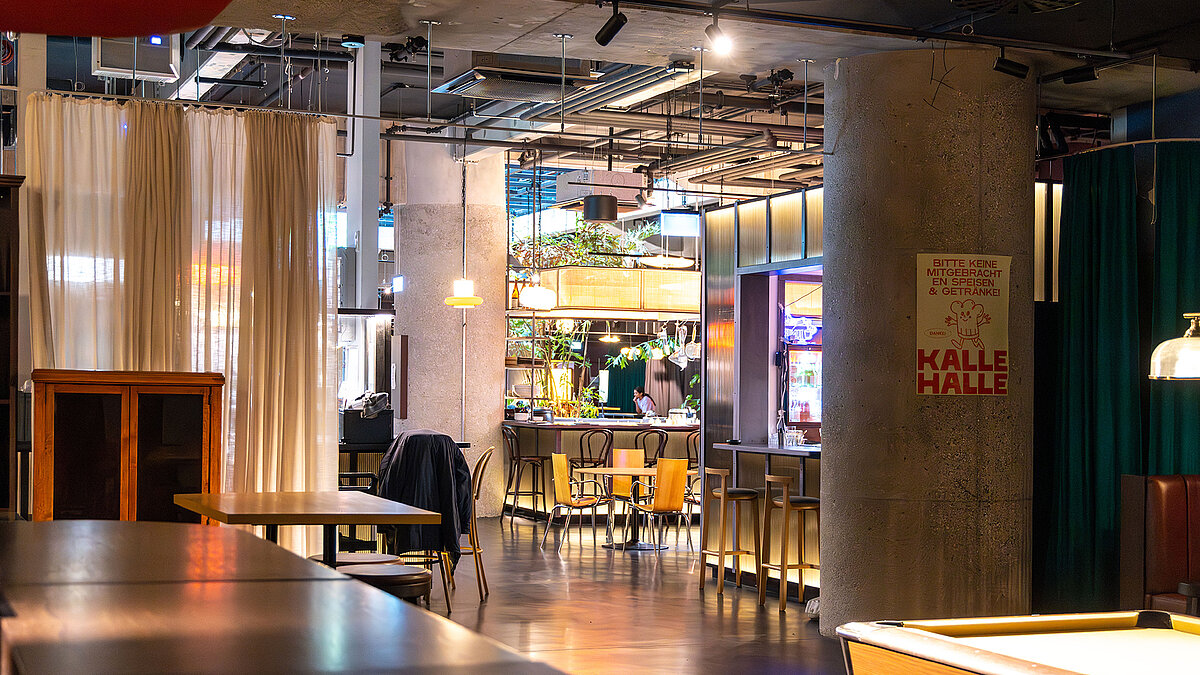 Interior view of Kalle Halle Neukölln with dining area