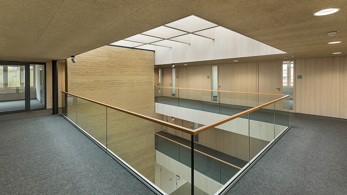 Modern interior design with glass railings and glass roof in the green centre of Immenstadt.