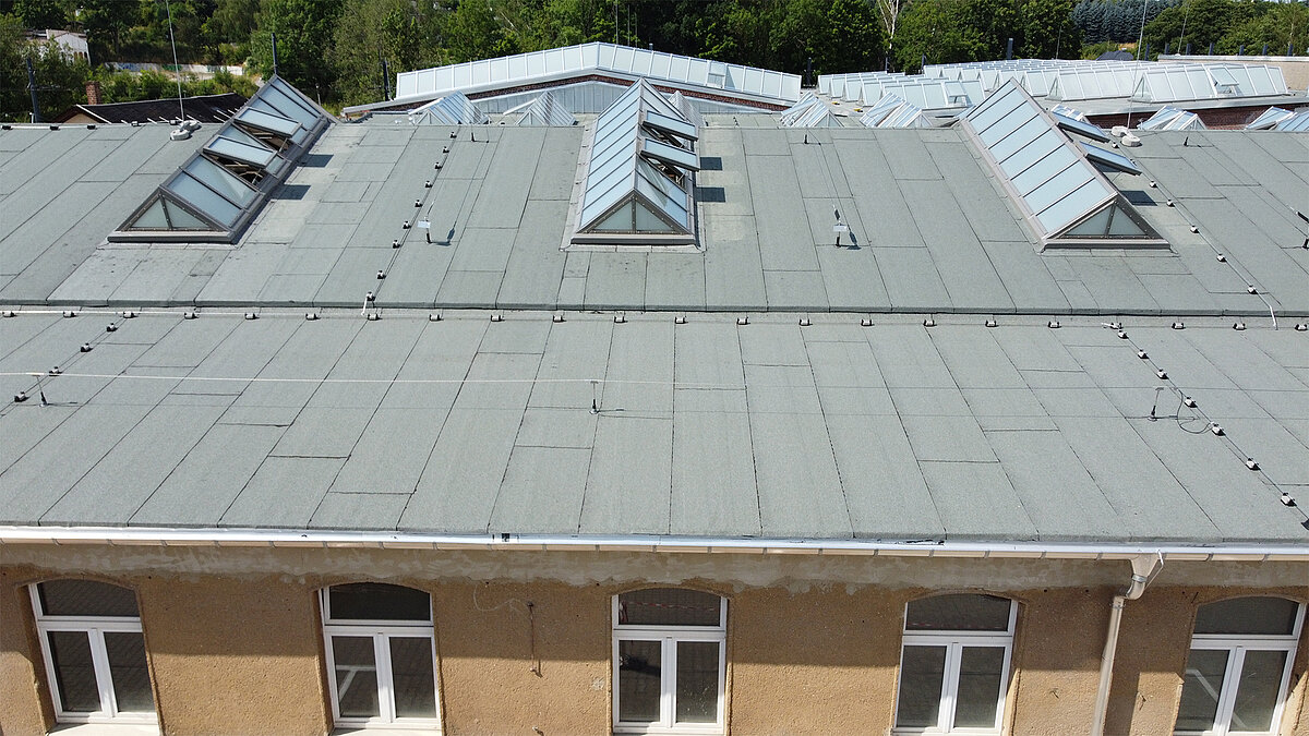 Roof view of the Chemnitz Tram Museum with Glass Roof PR60 in shed roof design on the historic hall roof