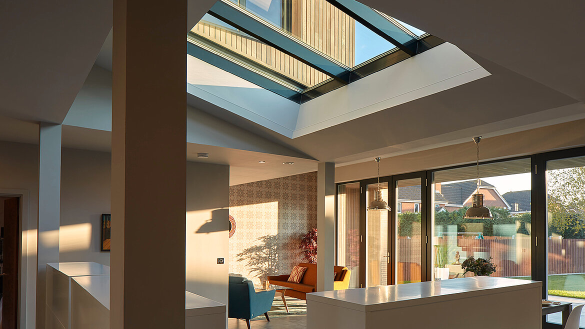 Modern home with large glass roof and abundant natural light in the living area.