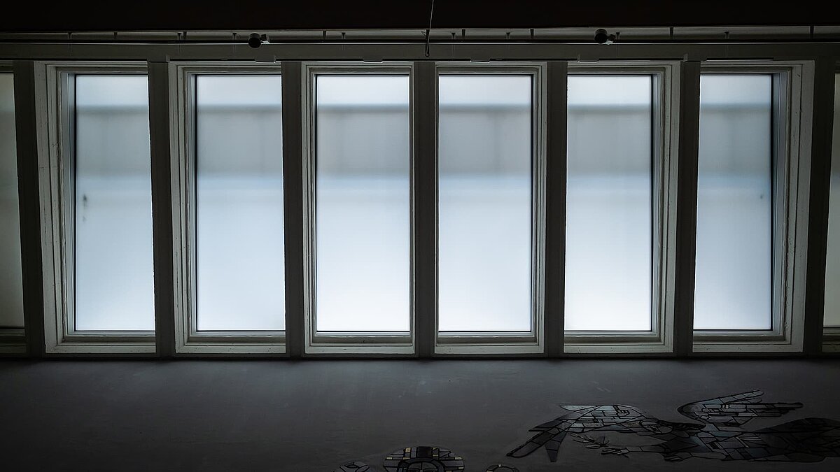 Interior view of Pauluskirche in Traunreut featuring LAMILUX flat roof windows FE, allowing daylight to enter.
